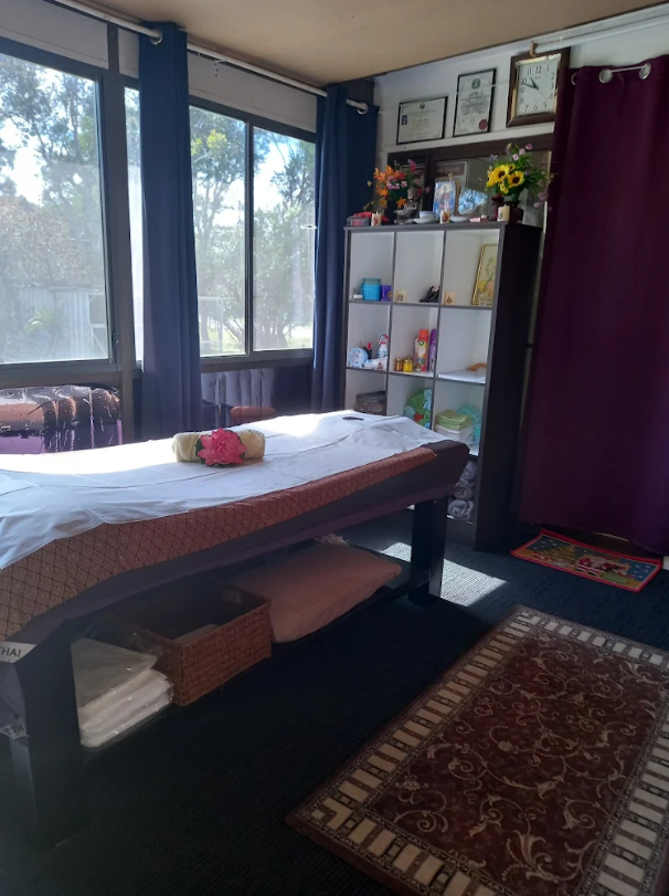 Massage treatment room with table and natural light