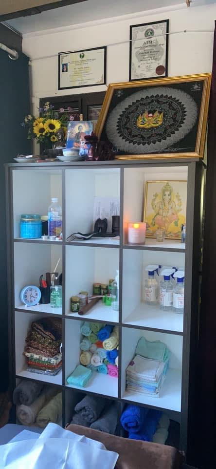 Nutchali's massage room with certificates and Thai decorations